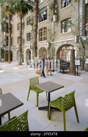 Shoppers or Tourists in Courtyard of the Restored Docks Building, now a Shopping Centre, Marseille France Stock Photo