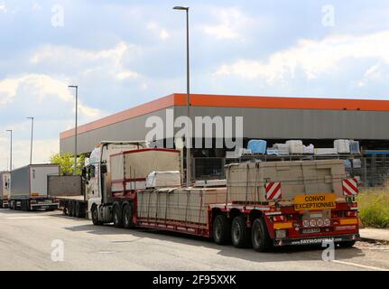 Exceptional convoy sign on a heavy lorry trailer parked in a side street in an industrial area of Santander Spain loaded with concrete breeze blocks Stock Photo
