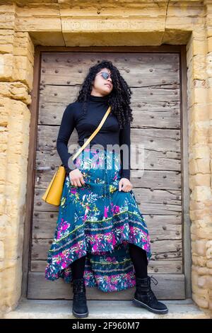 France, medieval town of Roanne. Pretty young girl in blue and black dress walking down the street in the old town. Concept of travel and wanderlust. Spring Stock Photo