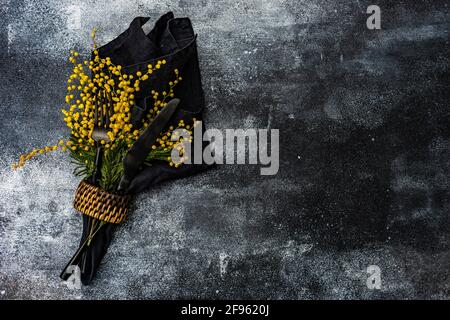 Spring mimosa flowers and table setting Stock Photo