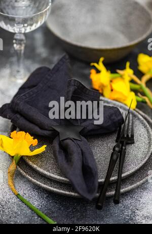 Spring table setting with daffodils Stock Photo