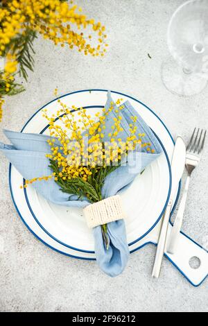 Spring mimosa flowers and table setting Stock Photo