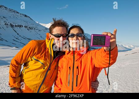 couple taking selfie with compact camera in Iceland Stock Photo