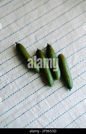 Fresh organic mini baby cucumbers on cloth, view from above. Flat lay, top  view, overhead Stock Photo - Alamy