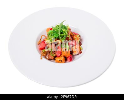 Delicious salmon salad with seaweed and strawberry topped with black sesame seeds. Isolated on a white background. Stock Photo