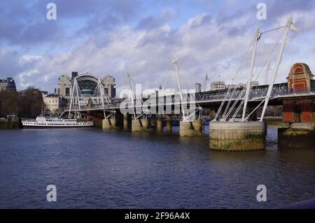 London, UK: view of the Golden Jubilee Bridges, with Charing Cross Station on the background Stock Photo