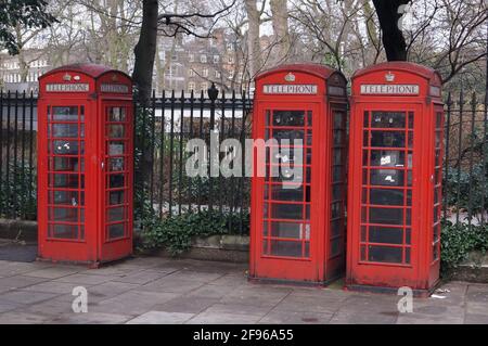 Three traditional red British telephone boxes in Russel Square, London (UK) Stock Photo