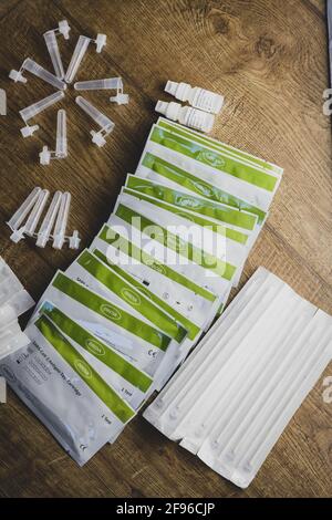 Home testing kit for school children and NHS staff, also called Lateral Flow tests for Covid 19, for testing at home. Covid immunisation cards. Stock Photo