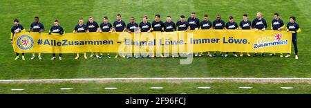 Brunswick, Germany. 16th Apr, 2021. Football: 2. Bundesliga, Eintracht Braunschweig - SC Paderborn 07, Matchday 29 at Eintracht-Stadion. Braunschweig players hold a poster. Credit: Swen Pförtner/dpa - IMPORTANT NOTE: In accordance with the regulations of the DFL Deutsche Fußball Liga and/or the DFB Deutscher Fußball-Bund, it is prohibited to use or have used photographs taken in the stadium and/or of the match in the form of sequence pictures and/or video-like photo series./dpa/Alamy Live News Stock Photo