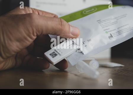 Home testing kit for school children and NHS staff, also called Lateral Flow tests for Covid 19, for testing at home. Covid immunisation cards. Stock Photo