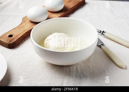 Ball of fresh buffalo mozzarella cheese in a bowl. Stock Photo