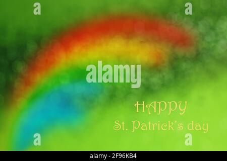 Saint Patrick's Day background. Blurred rainbow on sparkling green background. Stock Photo