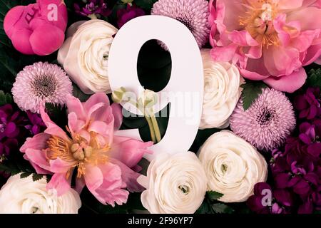 Layout with colorful flowers, leaves and number nine. Chrysanthemum Momoko, Peony, Matthiola, Ranunculus flowers background. Greeting card. Trendy bac Stock Photo