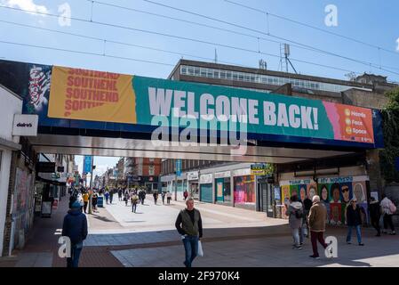 Welcome back message on bridge, High Street, Southend on Sea, Essex, UK, as England moves to step 2 of roadmap out of COVID 19 lockdown, with shoppers Stock Photo