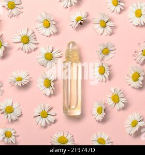 Pattern with daisy flowers and bottle on pink backround. Stock Photo