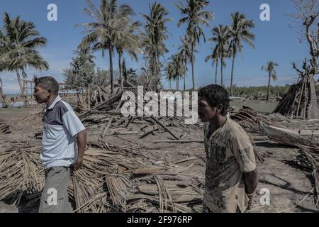 Malaka, Indonesia. 16th Apr, 2021. Yulius Fahik (R) and his brother walk around destroyed houses during the aftermath of flash floods and landslides that hit several areas in East Nusa Tenggara. According to data from the National Disaster Management Agency (BNPB), the number of fatalities due to flash floods triggered by Seroja Tropical Cyclone that occurred on April 4, 2021 reached 181 people. (Photo by Risa Krisadhi/SOPA Images/Sipa USA) Credit: Sipa USA/Alamy Live News Stock Photo