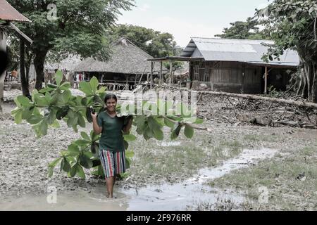 Malaka, Indonesia. 16th Apr, 2021. A woman walks through a flooded area during the aftermath of flash floods and landslides that hit several areas in East Nusa Tenggara. According to data from the National Disaster Management Agency (BNPB), the number of fatalities due to flash floods triggered by Seroja Tropical Cyclone that occurred on April 4, 2021 reached 181 people. (Photo by Risa Krisadhi/SOPA Images/Sipa USA) Credit: Sipa USA/Alamy Live News Stock Photo