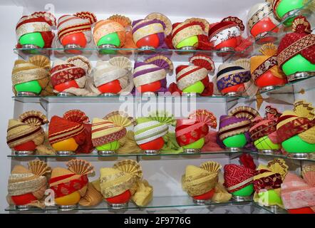 Beawar, Rajasthan, India, April 16, 2021: Colorful turbans on display for sale at a shop during wedding season amid the ongoing coronavirus pandemic, in Beawar. Many weddings postponed due to the rise of COVID-19 cases across the country. Credit: Sumit Saraswat/Alamy Live News Stock Photo