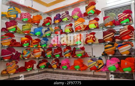 Beawar, Rajasthan, India, April 16, 2021: Colorful turbans on display for sale at a shop during wedding season amid the ongoing coronavirus pandemic, in Beawar. Many weddings postponed due to the rise of COVID-19 cases across the country. Credit: Sumit Saraswat/Alamy Live News Stock Photo