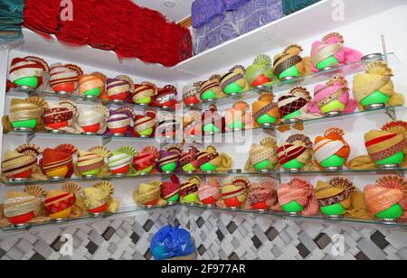 Beawar, Rajasthan, India, April 16, 2021: Colorful turbans on display for sale at a shop during wedding season amid the ongoing coronavirus pandemic, in Beawar. Many weddings postponed due to the rise of COVID-19 cases across the country. Credit: Sumit Saraswat/Alamy Live News Stock Photo