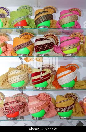 Beawar, Rajasthan, India, April 16, 2021: Colorful turbans on display for sale at a shop during wedding season amid the ongoing coronavirus pandemic, in Beawar. Many weddings postponed due to the rise of COVID-19 cases across the country. Credit: Sumit Saraswat/Alamy Live News Stock Photo