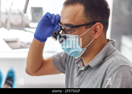 Modern dental surgery, face of a female doctor working on a patient. Dental implantation operation on a patient at dentistry office Stock Photo