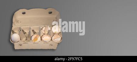 Banner with eggs packaging carton box with 5 broken chicken eggs and one not, Design concept for uncertainty, fate, fear, cruelty of life, unavoidable Stock Photo