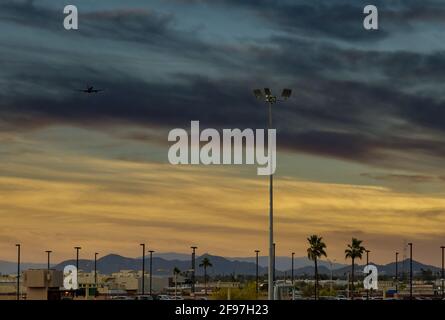 Modern international airport during sunset a passenger plane in flight Stock Photo