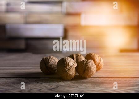 Walnuts on a wooden table close up with place for text, background. Stock Photo