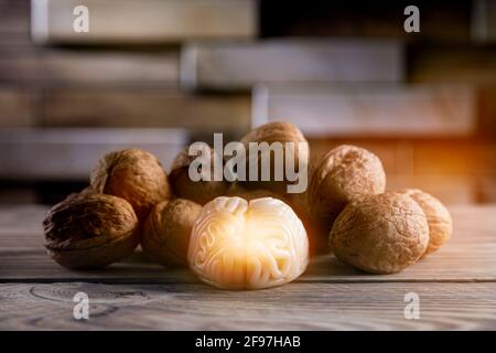Walnuts like healthy food for the brain. Shape of human brain is surrounded by walnut kernels. It symbolizes how brain similarity with walnuts and pro Stock Photo