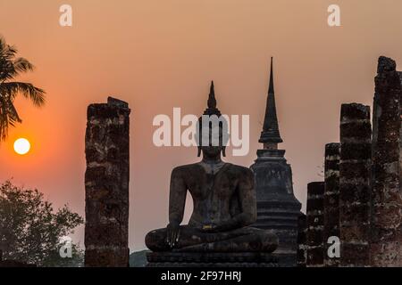 Thailand, Sukothai, Wat Mahathat temple, Buddha statue, sunset Stock Photo