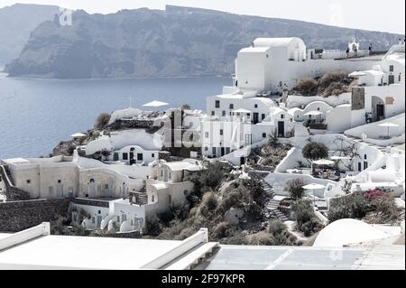 Scenic view of Oia on Santorini island with traditional cycladic, white houses and churches with blue domes over the Caldera, Aegean sea, Greece, Stock Photo