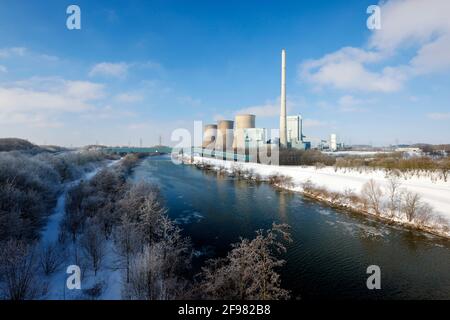 Hamm, North Rhine-Westphalia, Germany - Sunny winter landscape in the Ruhr area, ice and snow on the Lippe, in the back the RWE Gersteinwerk gas power plant. Stock Photo