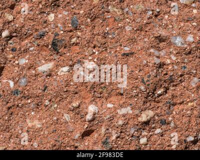 orange grunge plaster texture with multi color grit and stones grain background Stock Photo