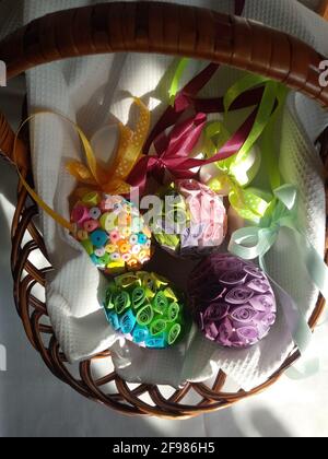 Eggs decorated with ribbons and colored paper in a basket Stock Photo