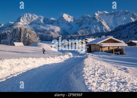 Winter hiking trail at the hamlet of Gerold against the Karwendel Mountains, Krün, Werdenfelser Land, Upper Bavaria, Bavaria, Germany Stock Photo
