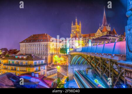 Night view of the Lausanne gothic cathedral Behind Charles Bessieres bridge, Switzerland Stock Photo