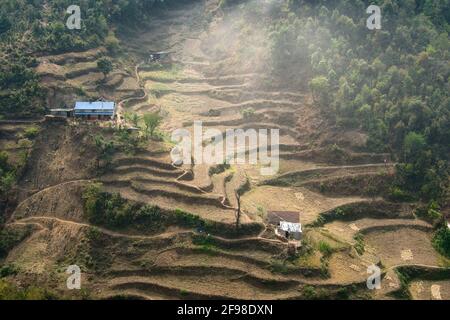 Beautiful view of terraced fields and trails on a hillside with two houses Stock Photo