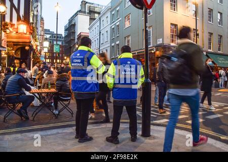 London, UK. 16th Apr, 2021. Covid-19 marshals on patrol in Old Compton Street, Soho. Crowds of people packed the bars and restaurants in Central London on the first Friday since lockdown rules were relaxed. Credit: SOPA Images Limited/Alamy Live News Stock Photo