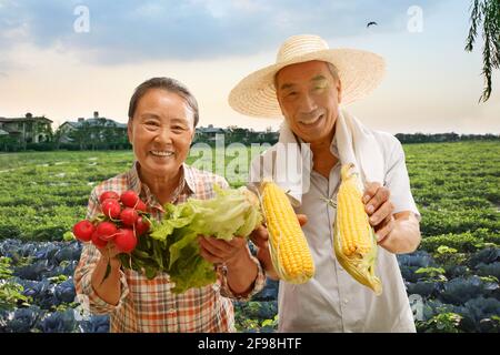 Peasant couple show agricultural products Stock Photo