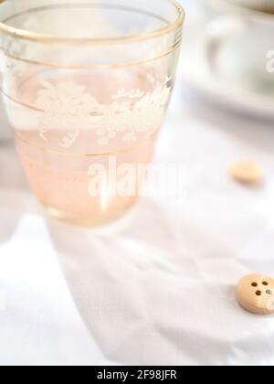Pretty pink glass in the light with a bright white background Stock Photo