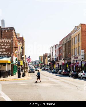 BRISTOL, TN-VA, USA-7 APRIL 2021: A view of State Sreet from Piedmont Avenue, on a sunny day.  Woman crosses the street. Stock Photo