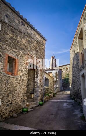 Village alley in Arboussols with a view of Saint Sauveur Church. It was built in the 17th century. Stock Photo