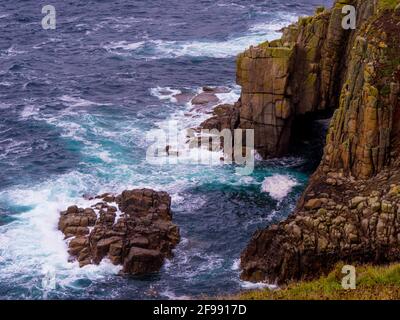 Wild and strong waves hitting against rocks in the ocean Stock Photo