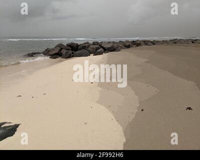 Ash on the sand of a Barbados beach from the volcanic eruption of Saint Vincent and Grenadines La Soufrière. Stock Photo