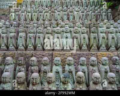Small praying monk statues at Hase Dera Temple in Kamakura Stock Photo