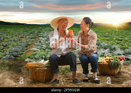 Peasant couple sitting in on-farm water Stock Photo