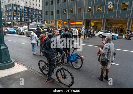 NEW YORK, NY – APRIL 16: Bystanders watch the protest outside the Netherland consulate in Manhattan blocking traffic and calling for reparations for Blacks on April 16, 2021 in New York City.   New York Police Department (NYPD) Officers arrested two activists after they refused to clear the road. Stock Photo