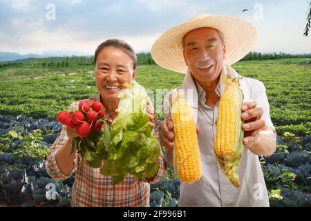 Peasant couple show agricultural products Stock Photo