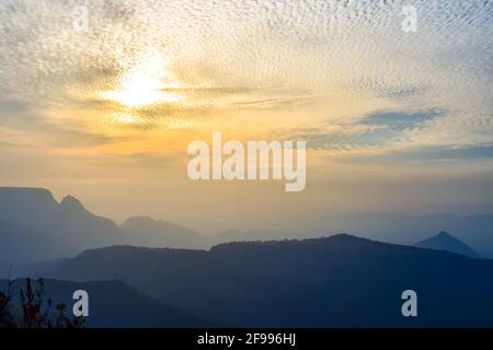 Spectacular silhouette view during sunset in Sahyadri mountain range on a winter evening from Sunset point at Matheran, Maharashtra, India. Stock Photo